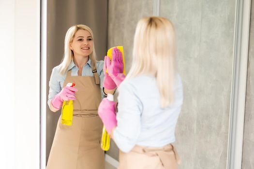 Adult woman is cleaning the apartment