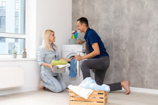 man and woman with washing machine in apartment