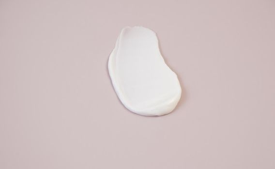 White cream texture on a pink background