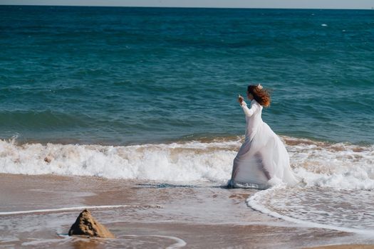 Woman in white dress freedom walk on ocean island. High quality photo