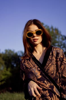 pretty woman in fashionable clothes sunglasses nature posing. High quality photo