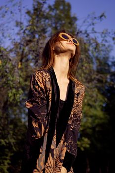 pretty woman wearing sunglasses outdoors fashion nature. High quality photo