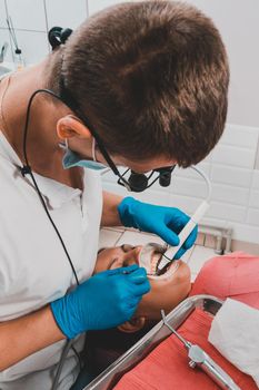 The dentist uses a scaler to remove tartar, oral hygiene.2020