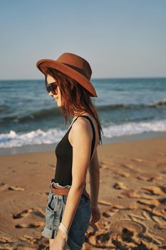 woman in trendy summer clothes by the ocean vacation sun. High quality photo