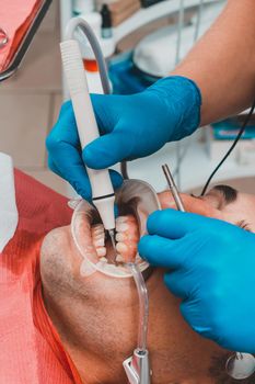 patient removing tartar,the dentist uses ultrasound to remove tartar,dental scaler.2020