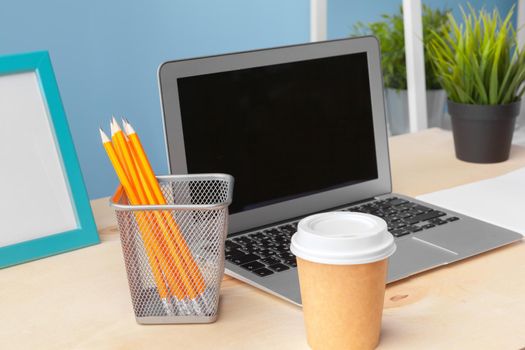 paperwork in the office and laptop on the desktop