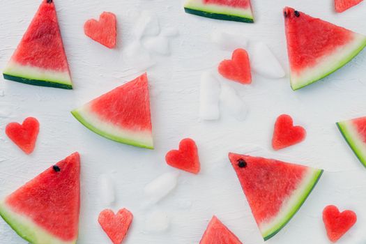 Watermelon hearts and slices pattern. Sliced watermelon on white background with ice. Flat lay, top view. watermelon slices on white