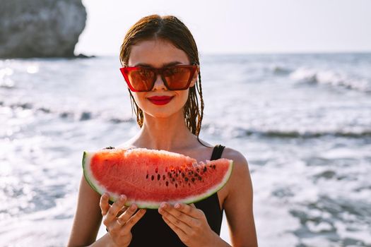 woman in swimsuit with watermelon outdoors sun fresh air. High quality photo