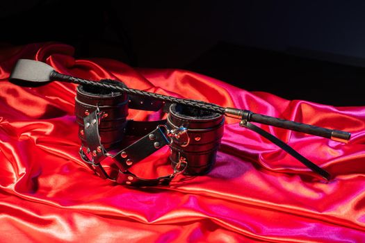 Adult sex games. Kinky lifestyle. Spank and Bondage on the red linen. Bdsm outfit - Image