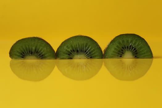 pieces of kiwi halves with a trend of Illuminating yellow color with a place to insert a copyspace.