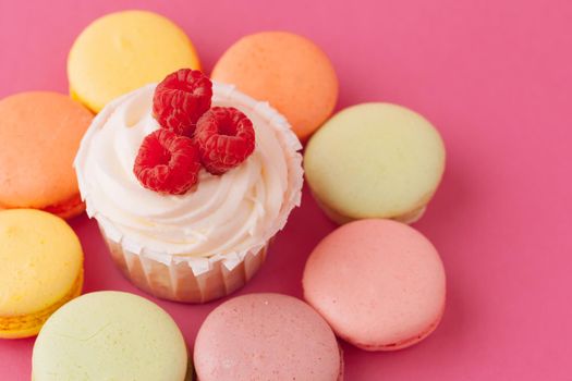 Yummy sweet cupcakes on light pink background