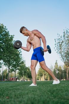 sporty man in park exercise crossfit workout. High quality photo