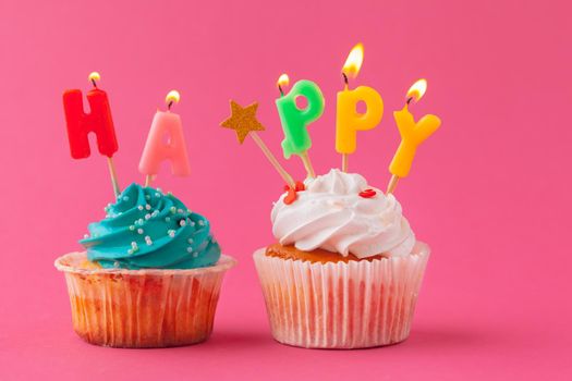Delicious cupcakes with candles on a colored background. Festive background, birthday