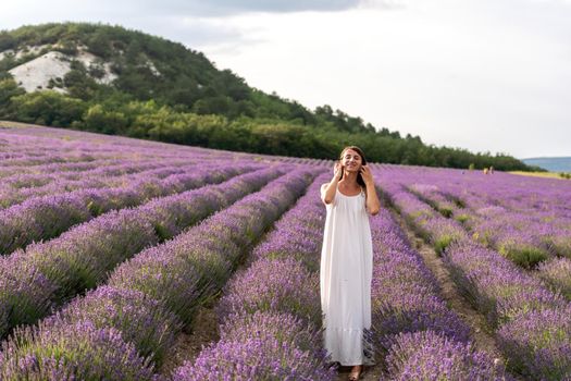 Lavender flower blooming scented fields in endless rows. Selective focus on Bushes of lavender purple aromatic flowers at lavender field. Abstract blur for background.