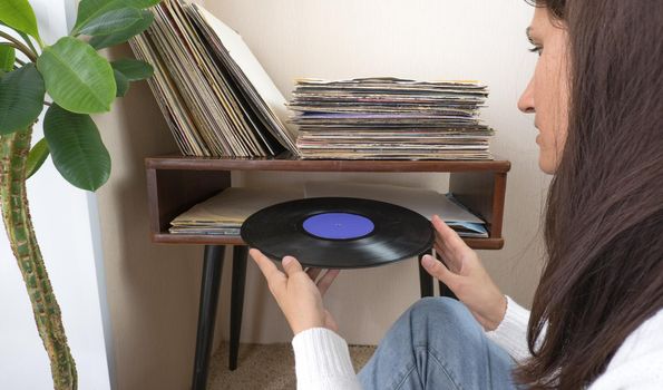 Playing vinyl records. Listening music, leisure time, staying home