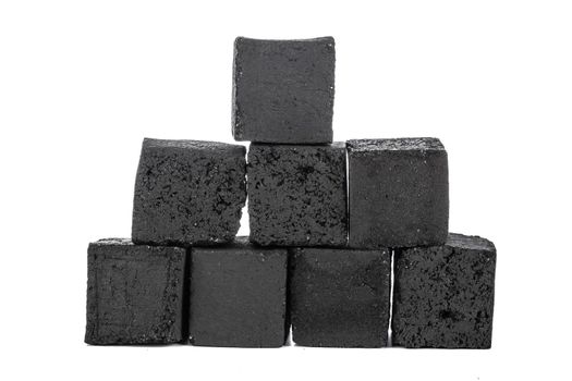 Group of charcoal cubes isolated on white background