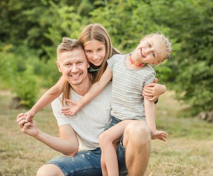 Happy family hugging and smiling together