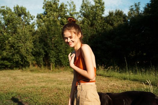 Cheerful Woman and a dog in the nature games Friendship. High quality photo