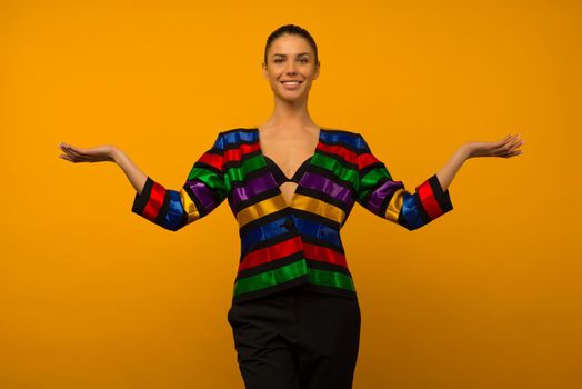 Young lesbian girl and an LGBT community representative posing in a flag coloring jacket LGBTQ shows something - image