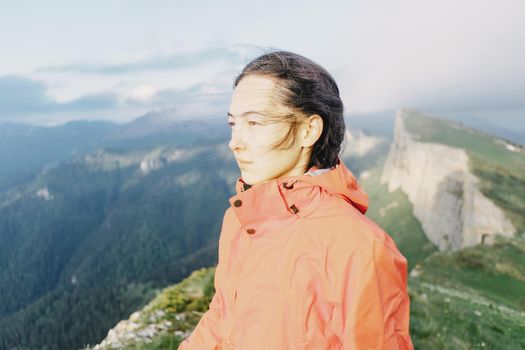 Portrait of hiker young woman on background of mountains.