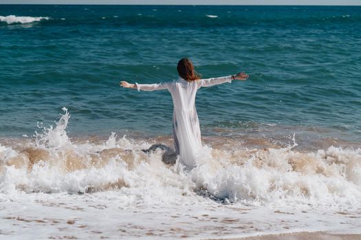Woman in white dress near the ocean walk fresh air landscape. High quality photo
