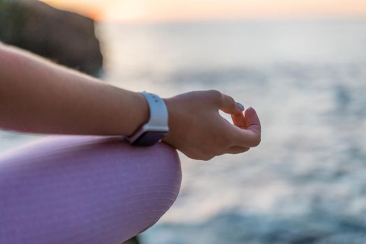 Young woman practicing yoga outdoors. Harmony and meditation concept. Healthy lifestyle.