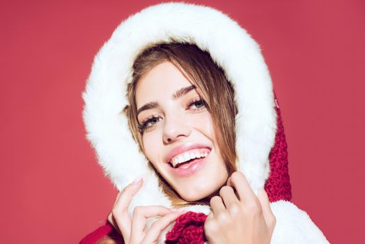 Woman in santa costume with pretty face. New year and christmas. Christmas woman in red hood, copy space.