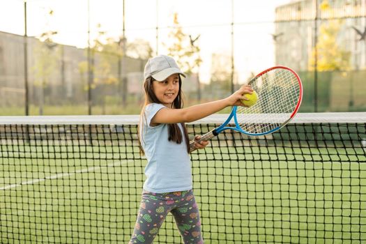 Nice girl with racket in hands playing game of tennis