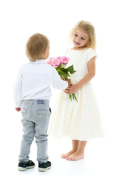 A little boy gives a girl a bouquet of flowers for his birthday. The concept of love, family values. Isolated on white background