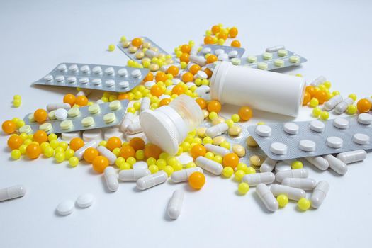 different colorful pills, capsules. Prevention, cure of influenza, coronavirus, covid-19, 2019-nCoV. yellow, orange vitamins, tablets on white background. medical healthcare, protection concept banner