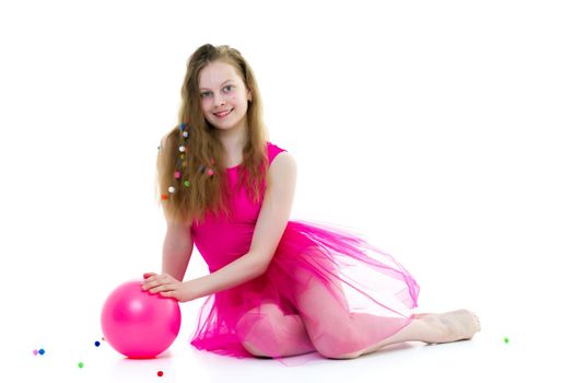 A charming little girl is engaged in fitness with a ball. The concept of gymnastics, health and sports. Isolated on white background.