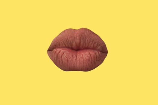 Woman's lips close up isolated on yellow background.