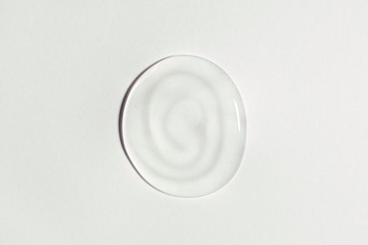 White transparent gel drop isolated on white background. Top view. Virus protection or cosmetics concept. Serum texture close up