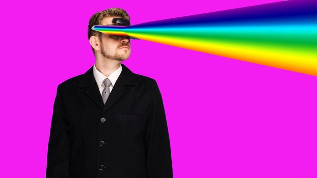 Businessman in a formal wear wearing virtual reality glasses projecting rainbow rays from the eyes - image