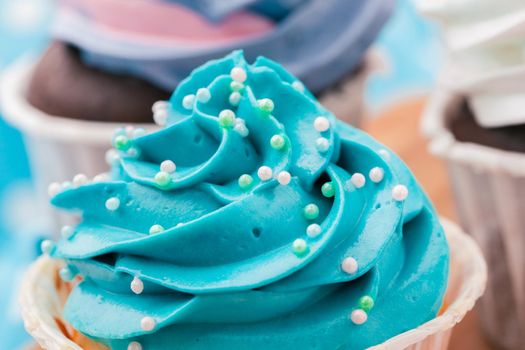 Side view of yummy cupcakes with assorted flavor. Shot on the table