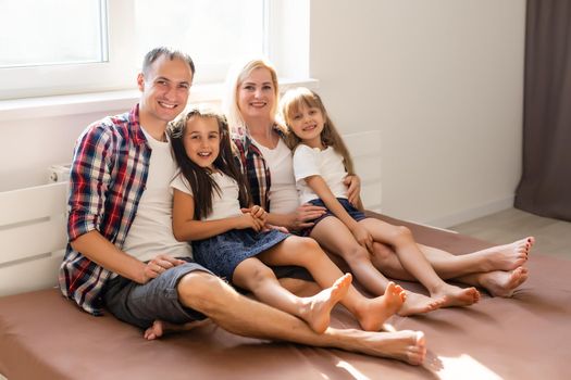 A happy family on brown bed in the bedroom