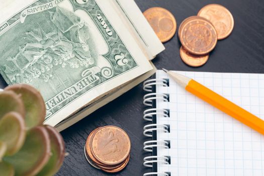 The close-up of accounting documents with money coins