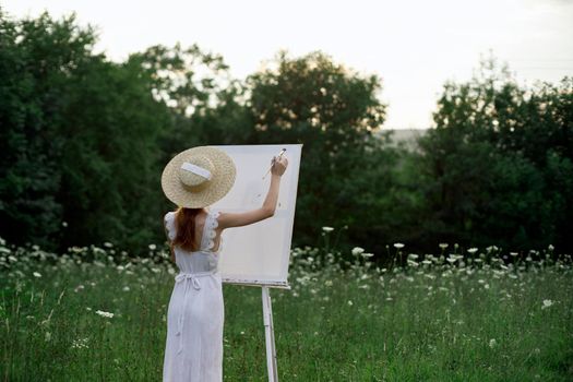 pretty woman in white dress outdoors drawing art creative. High quality photo