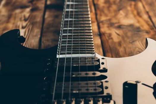 Close up photo of electric guitar fingerboard on dark background