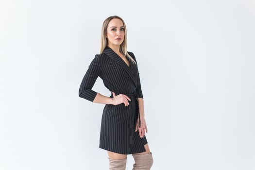 Fashion concept - Portrait of sexy business woman in a suit on white.