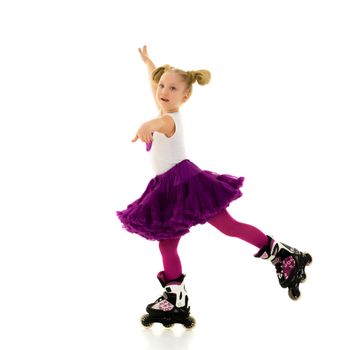 Cute little girl fun rollerblading. The concept of a healthy lifestyle, advertising. Isolated on white background.