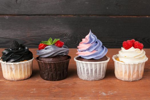 Delicious raspberry cupcakes on dark background - Handmade Sweet dessert