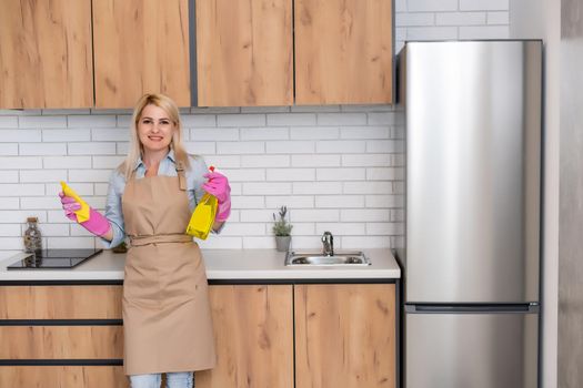 Young woman Cleaning Kitchen Cabinets