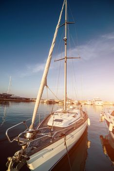 yacht in a berth on blue sea and blue sky background