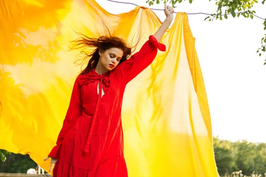 attractive woman in red dress posing yellow background nature. High quality photo