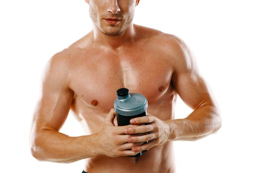 athletic man with pumped up muscular body sports drink light background. High quality photo