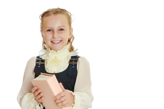 Dressy girl schoolgirl in black dress and white blouse holding a textbook and smiling cheerfully at the camera. Close-up.Isolated on white background.
