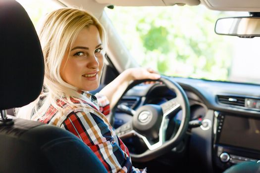 Young woman driving her car