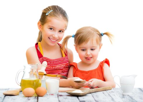 two cute little sisters cooking, white background