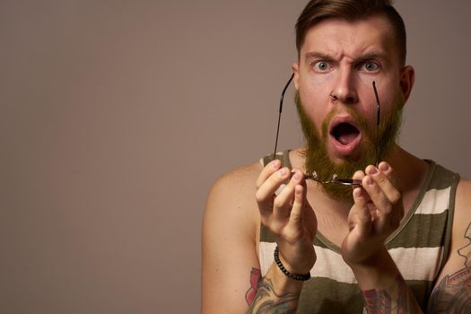 brutal man tattoos on his arms posing lifestyle form cropped view. High quality photo